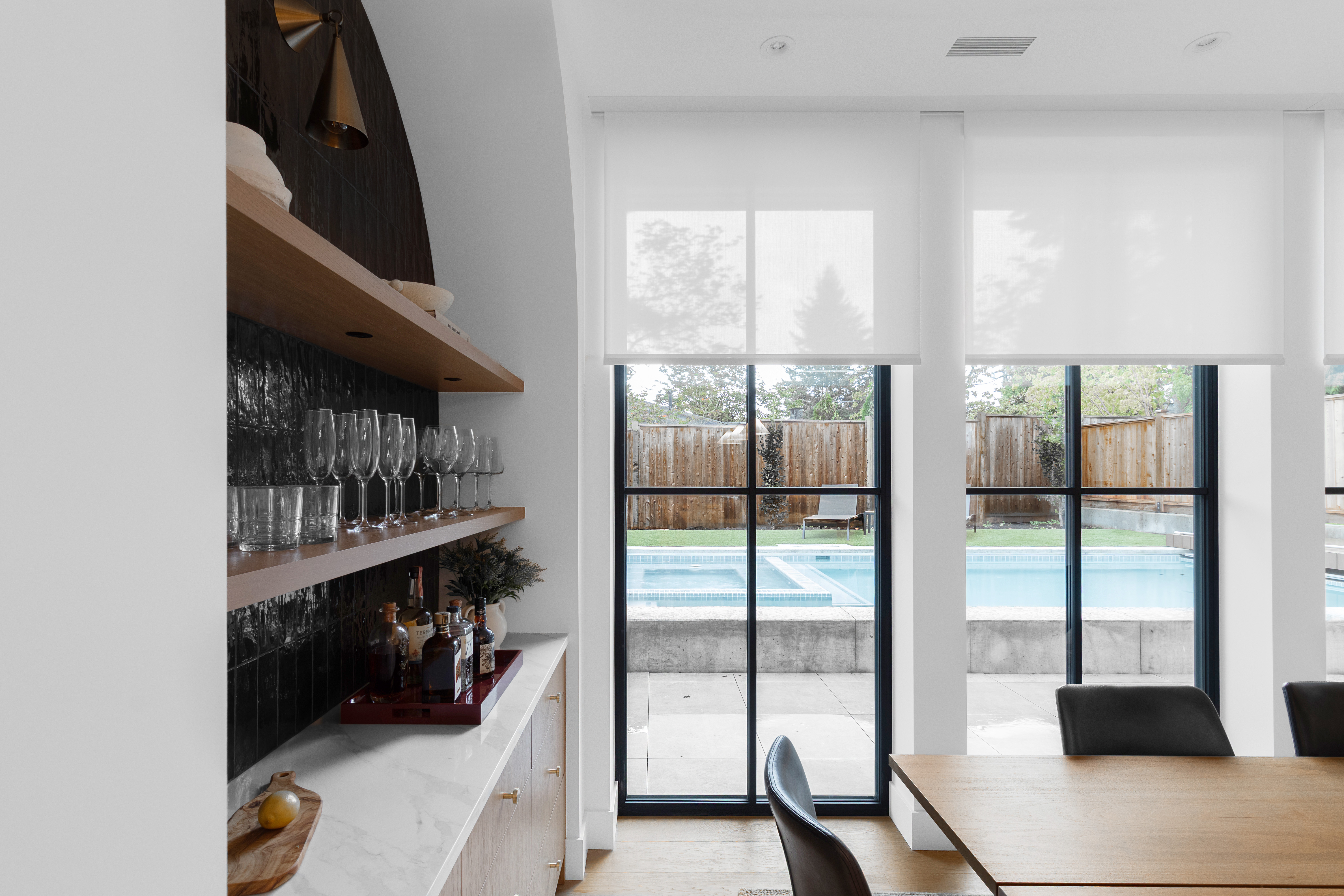 Motorized window shades filtering daylight at the Floralynn residence